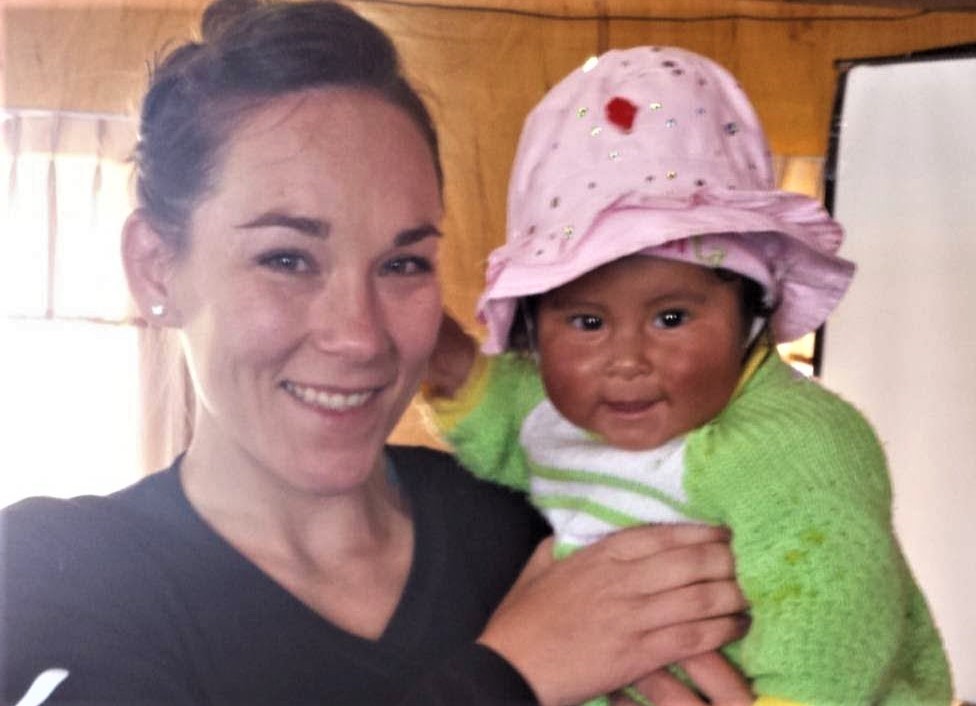 Celia with a child in Peru