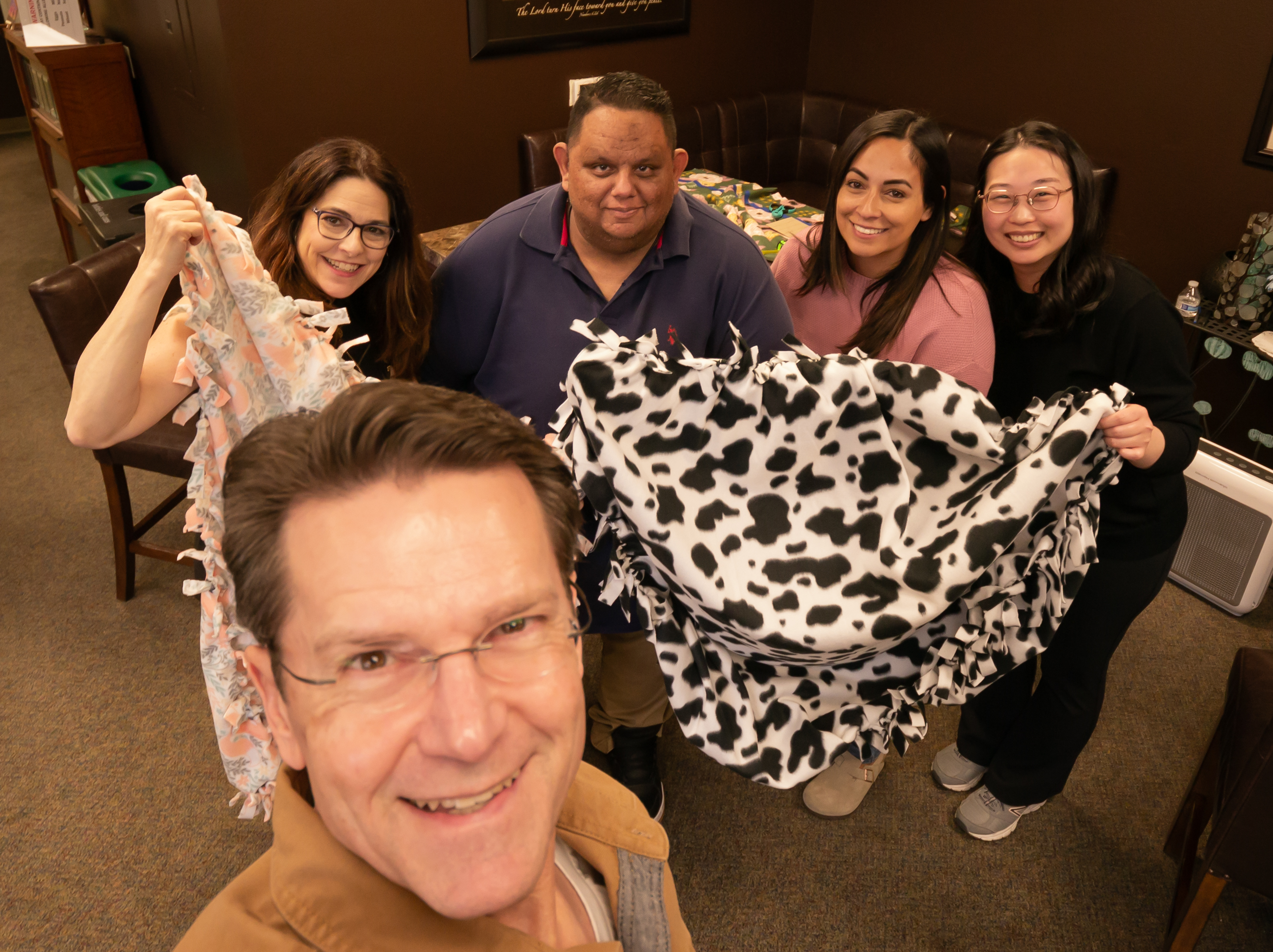 Students and faculty with blanket