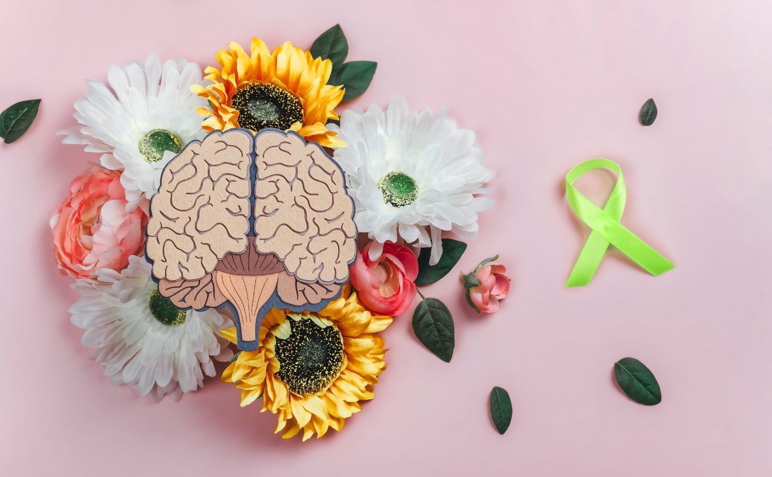 an image of a brain with flowers and a green ribbon