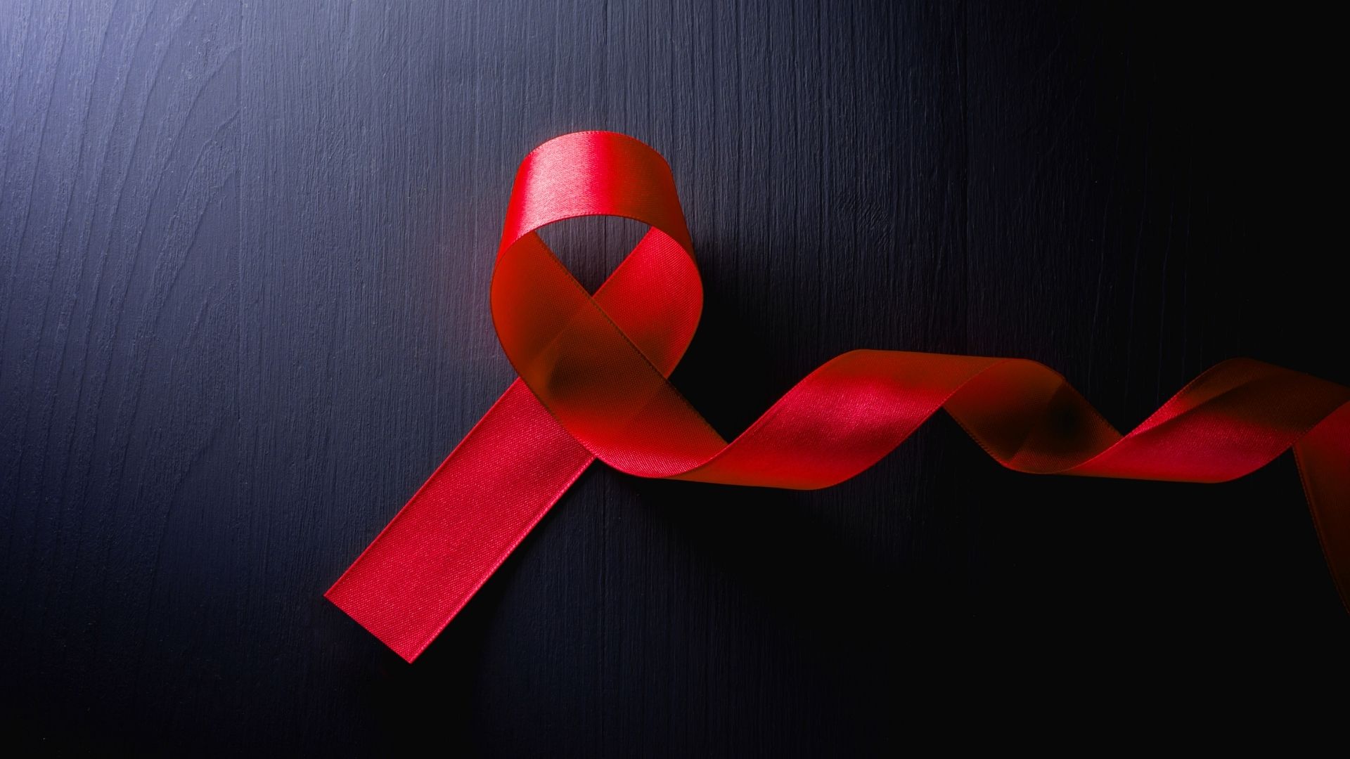 red ribbon on dark background