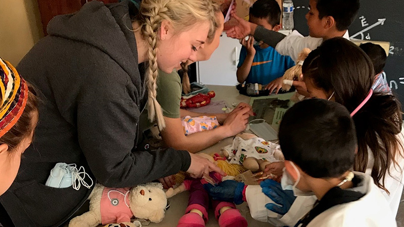 A Child Life Specialist graduate student helps run a teddy bear clinic.
