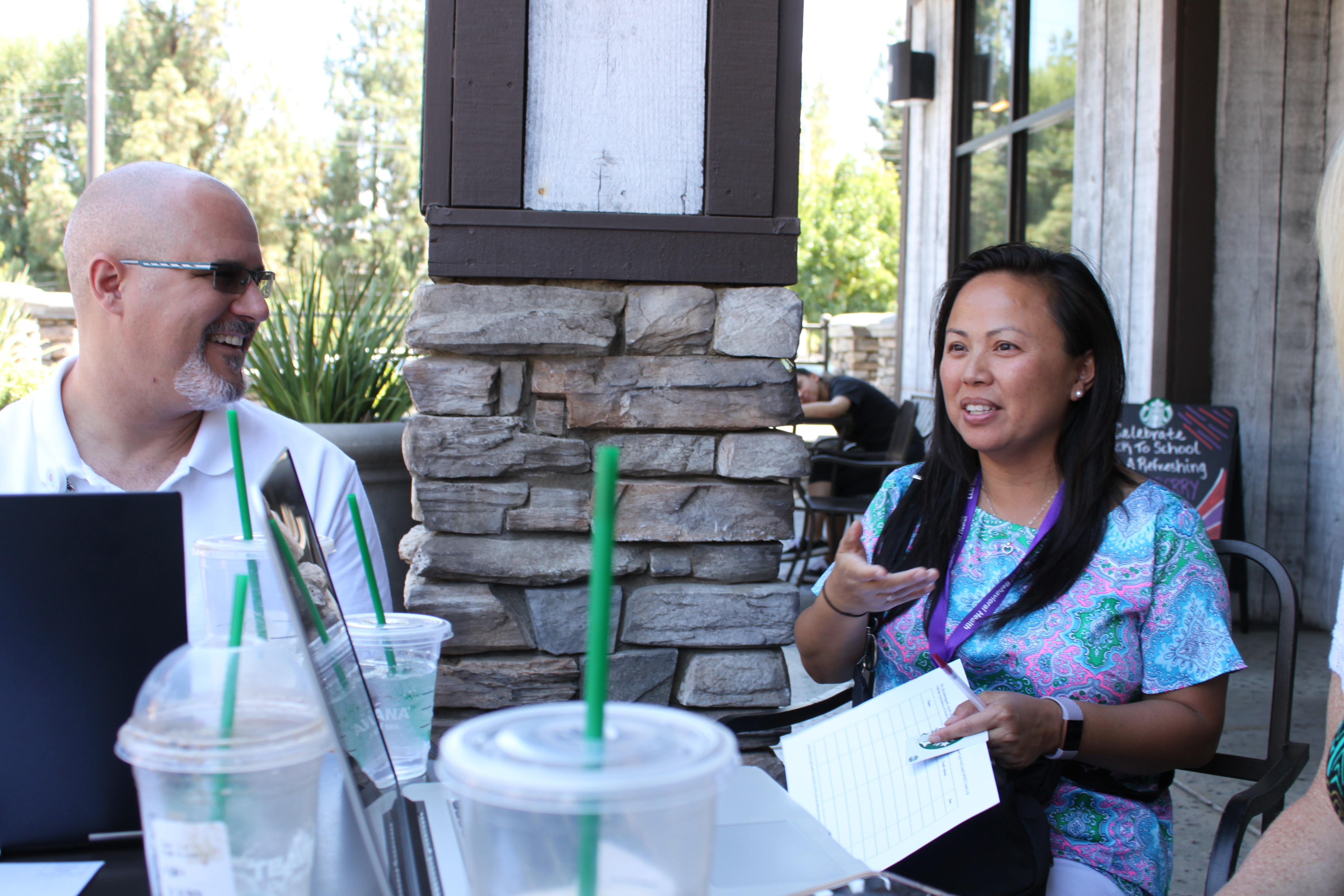 Dr. Adam Aréchiga talks with alumna Tori Dang in Riverside