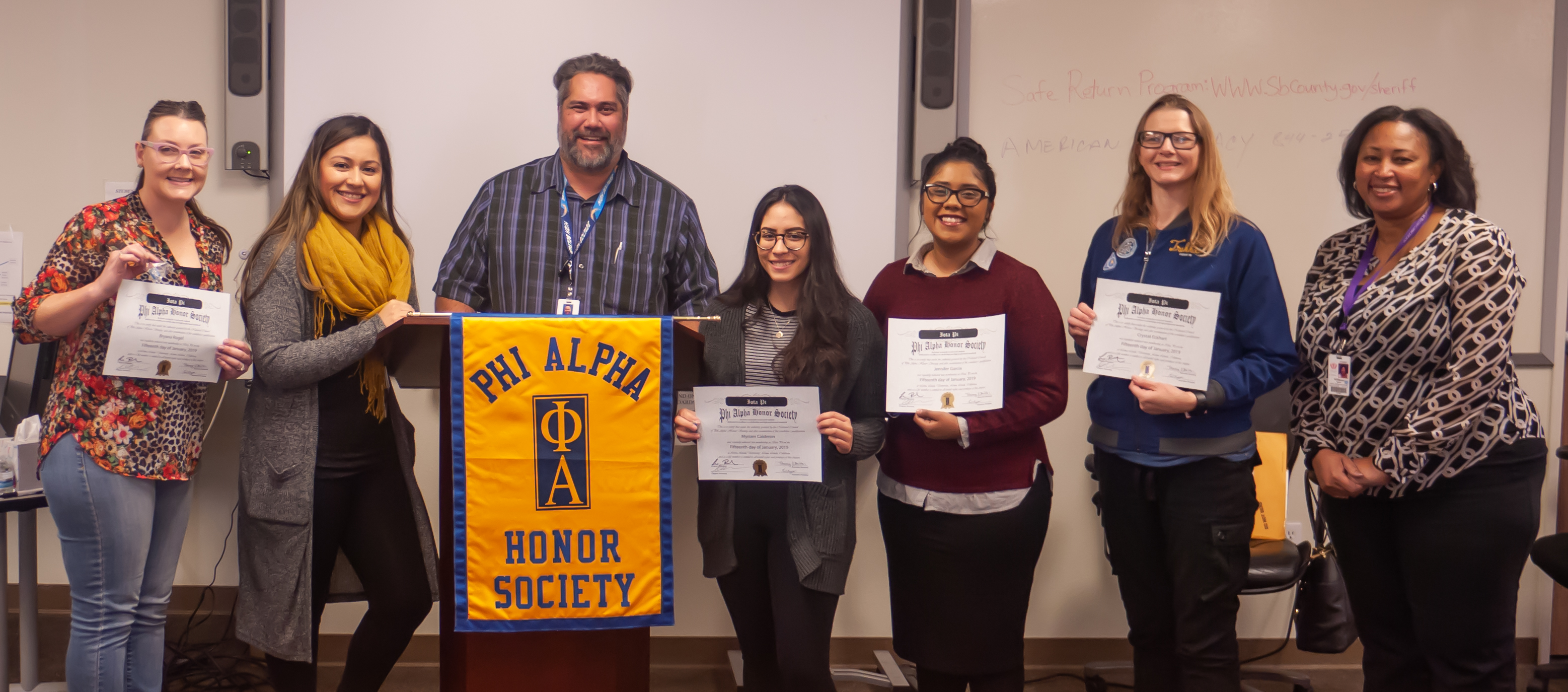 Phi Alpha honor society members and faculty advisor with awards.