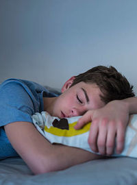 adolescent sleeping in bed