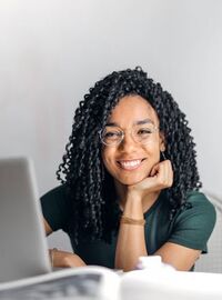 Smiling woman using laptop at a table