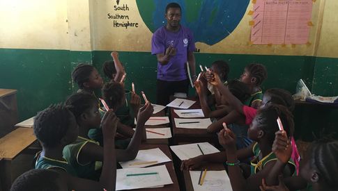 man teaching group of students in Sierra Leone