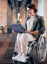 woman using laptop in wheelchair