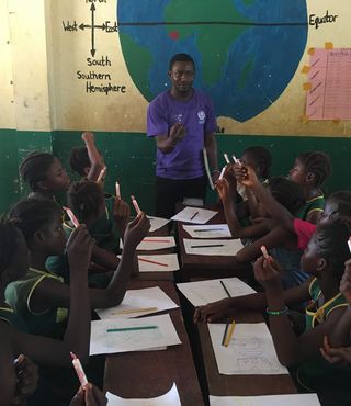 man teaching group of students in Sierra Leone