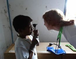child with stethoscope and woman in lab coat