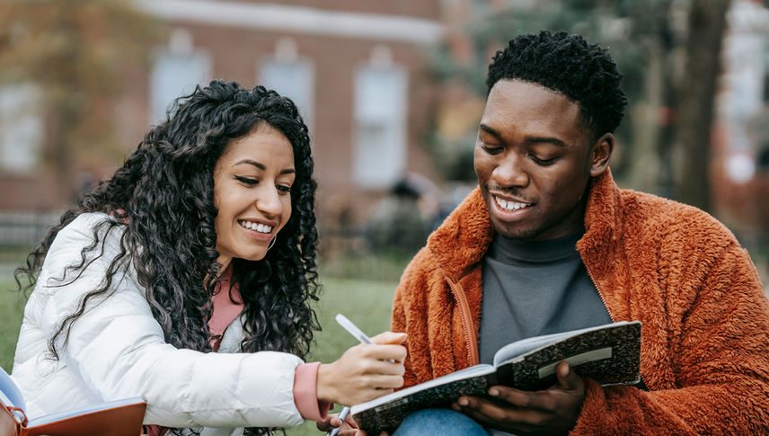 students smiling looking at books