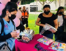 Welcome Back Bash attendees pick up cotton candy at the SBH booth