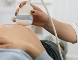 ultrasound tech scanning a pregnant belly