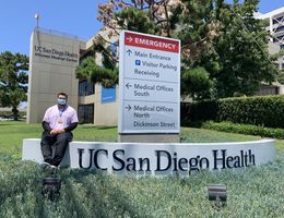 Child Life Specialist MS student Christian Hetzler in front of UC San Diego Health