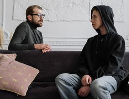 man counseling teenager