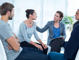 Therapist with patient and her family
