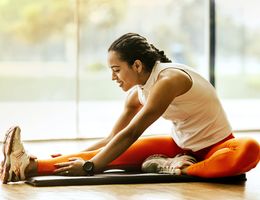 woman stretching on ground