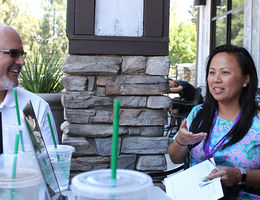 Dr. Adam Aréchiga talks with alumna Tori Dang in Riverside