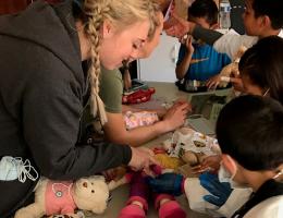 A Child Life Specialist graduate student helps run a teddy bear clinic.