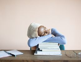 woman with pile of textbooks