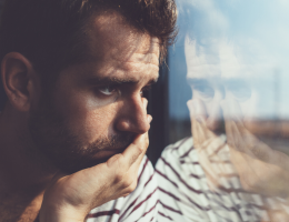 Sad man looking out window